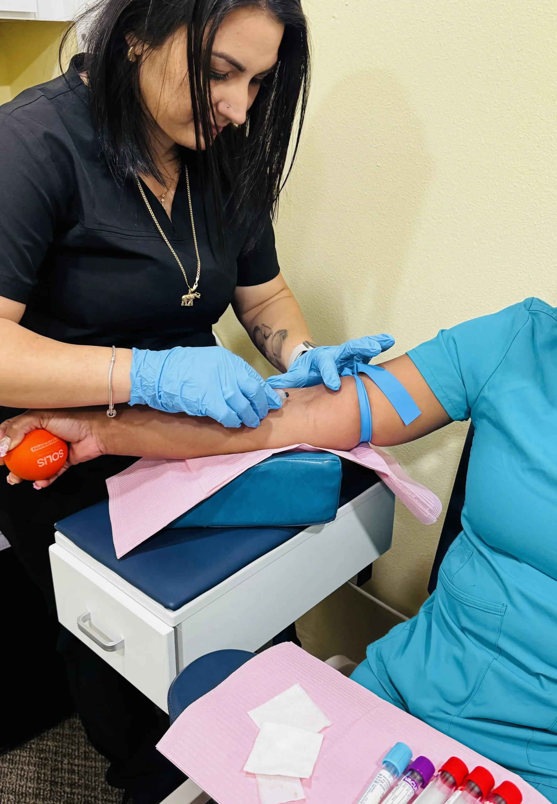 Smiling doctor performing an annual physical exam with a patient in a Tampa medical clinic, representing preventive healthcare in North Tampa and surrounding neighborhoods.